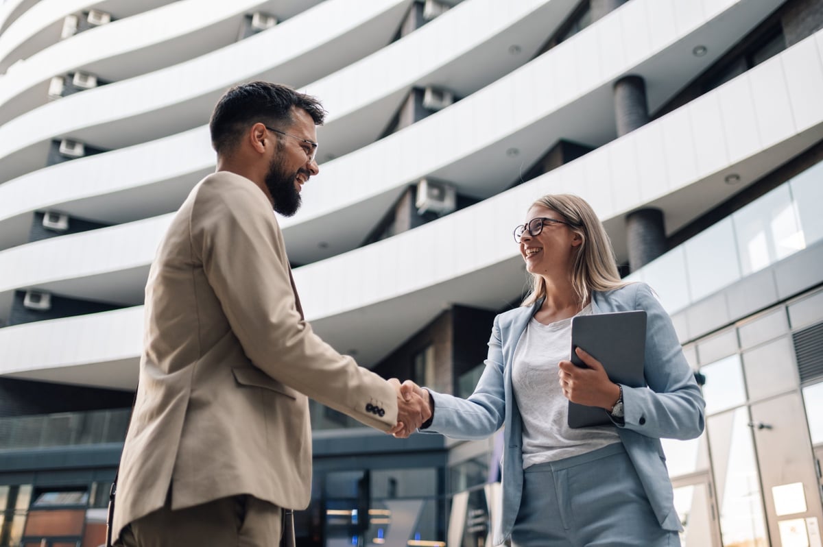 Two business partners shaking hands in a trusted professional relationship