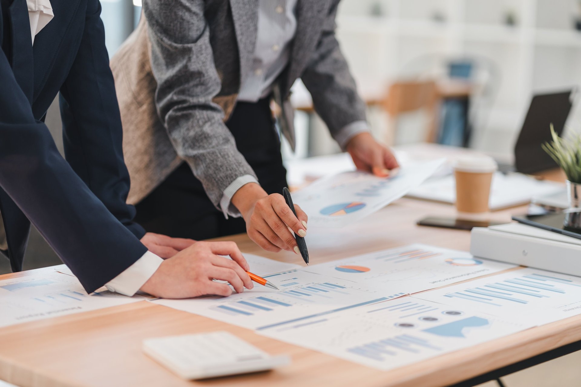 Business professionals analyzing financial charts and graphs, accounting and tax advisory