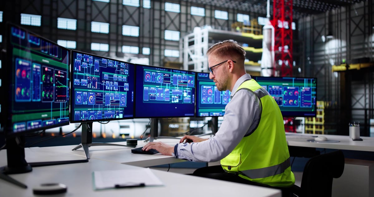 Industrial Engineer Operates SCADA System In High-Tech Factory Control Center