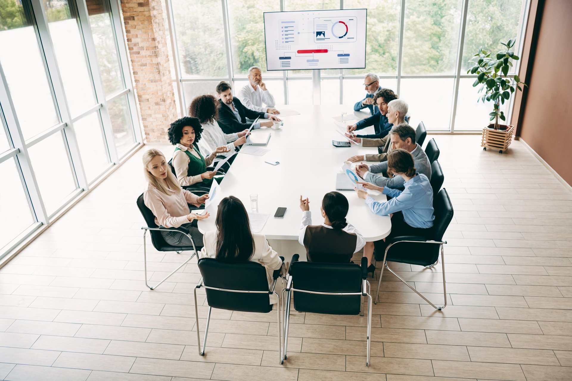 Professional team in corporate meeting discussing strategy in modern office setting