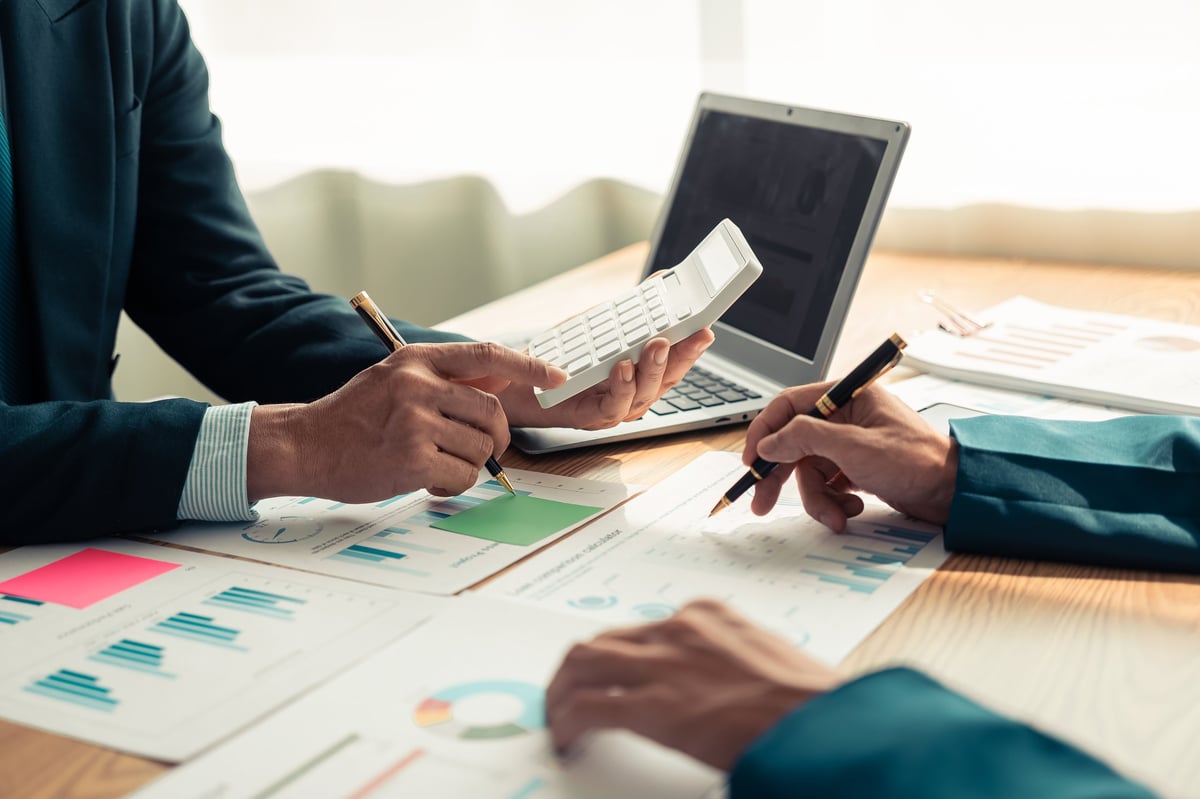 Confidential employee financial wellness review — advisor and client discussing debt resolution program options