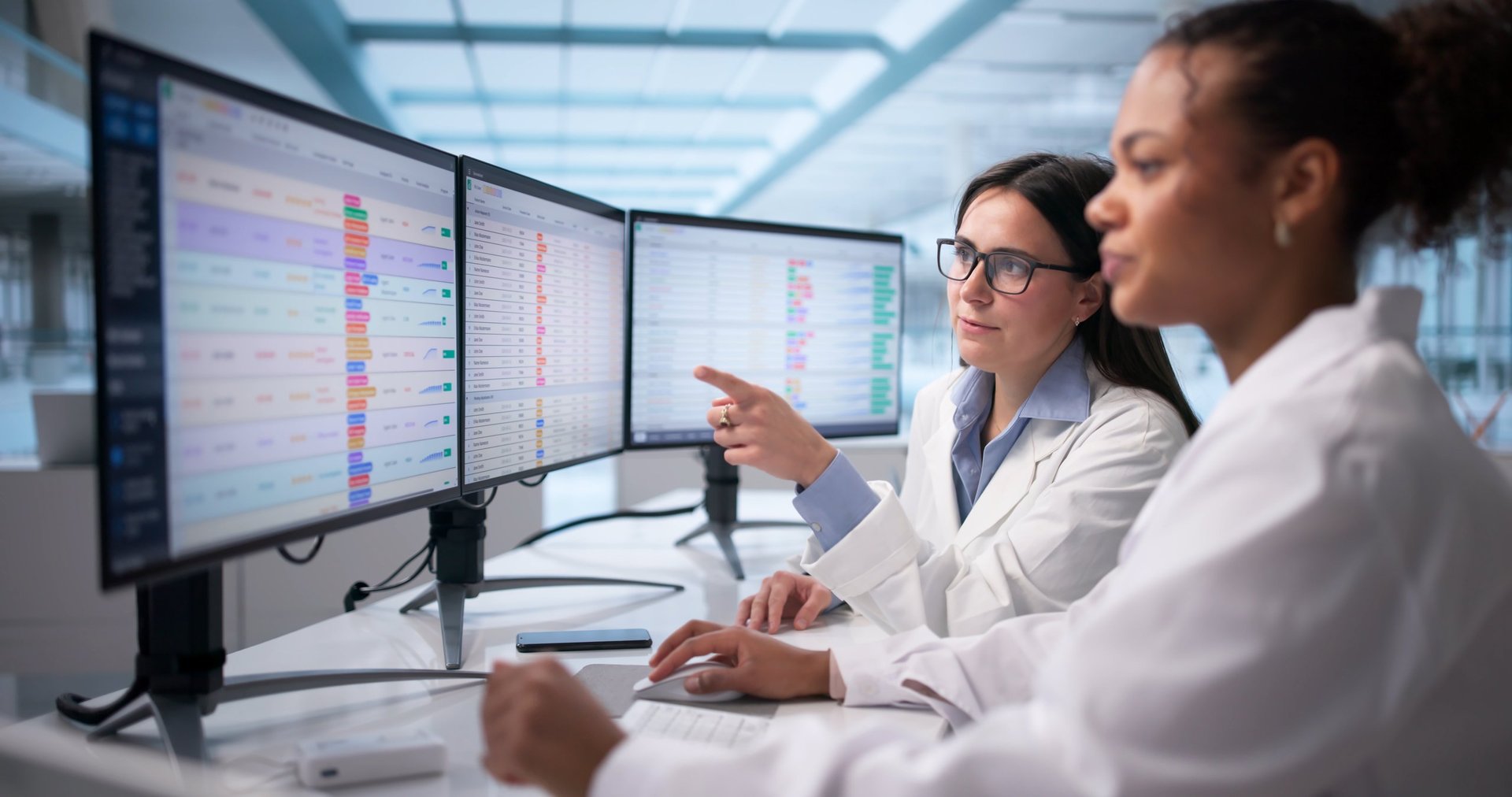 Female doctor analyzing medical data on hospital computer monitor