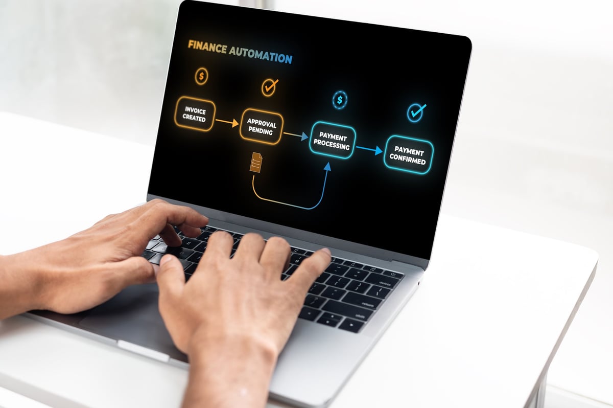 Professional using a laptop with an accounts payable finance automation dashboard