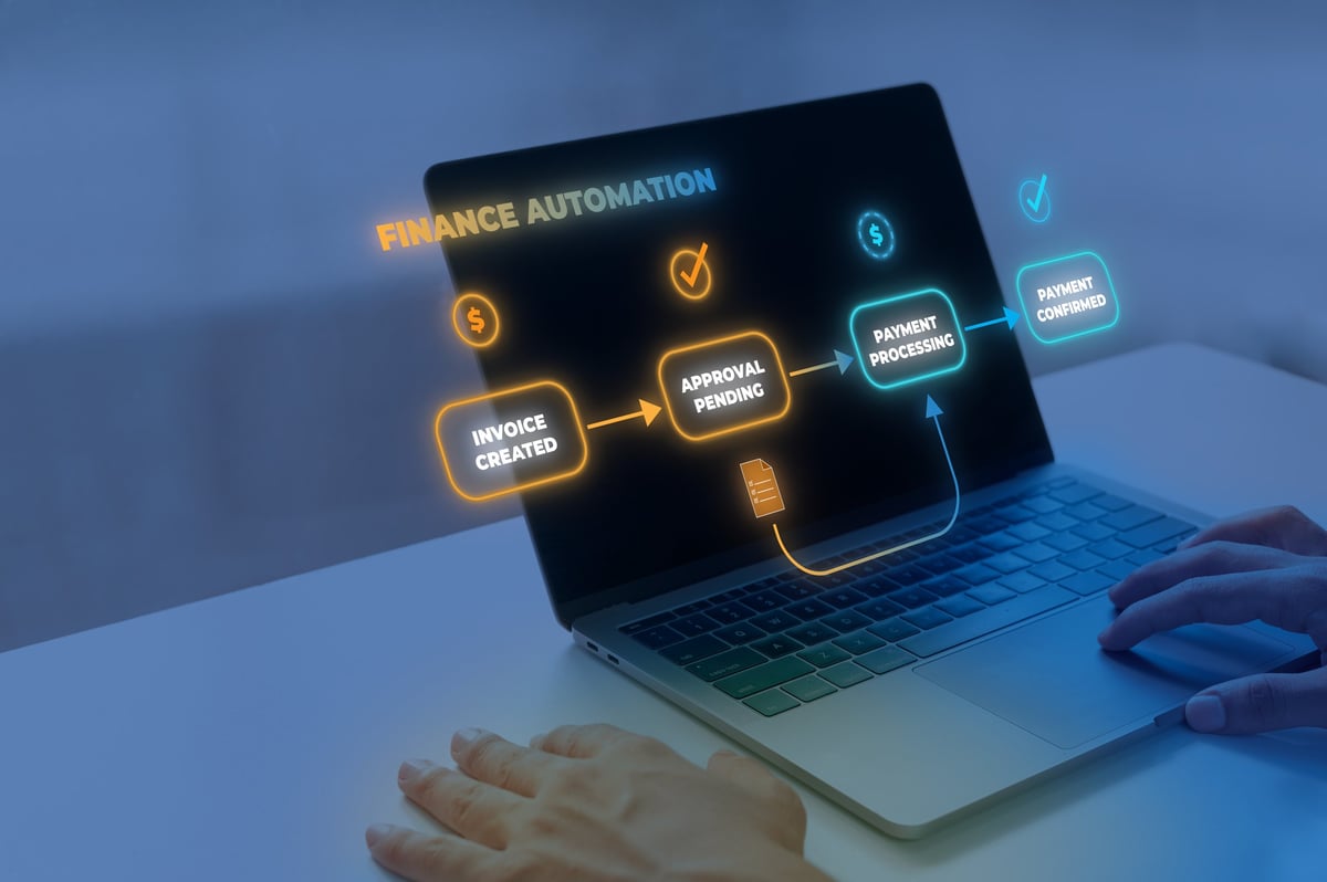 Professional using a laptop showing a finance automation dashboard with invoice creation, approval, and payment processing steps