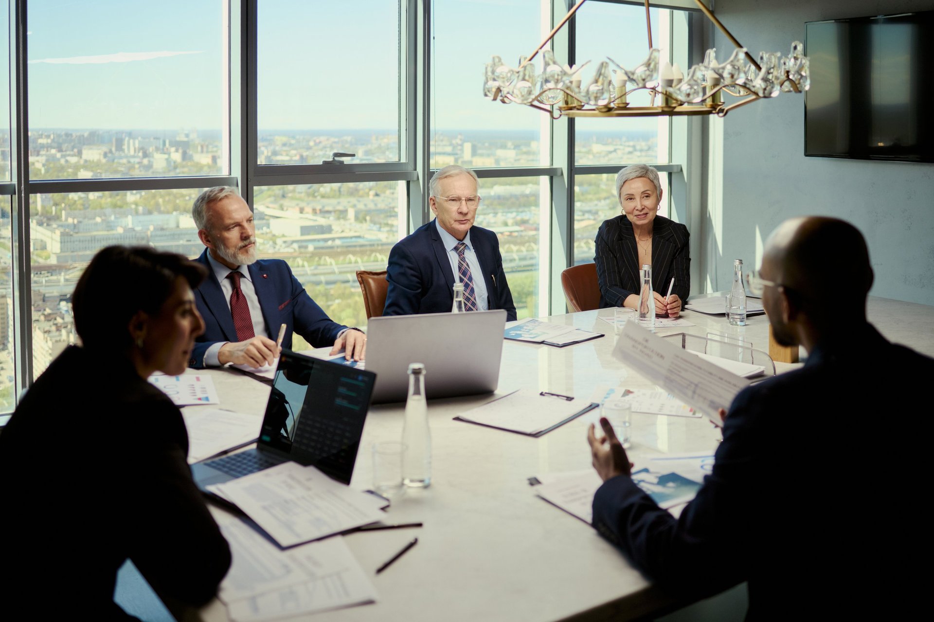 Business team discussing cost reduction strategy in boardroom